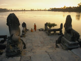 Two Buddhist Monks Sit at the Waters Edge at a Lake Temple in the Angkor Wat Complex