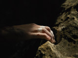 A Close View of a Climbers Hand Utilizing a Natural Hold