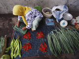 A Woman Sells Vegetables at an Open-Air Market in Malaysia