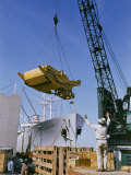 Buy A Ship Being Loaded with Farm Equipment at AllPosters.com