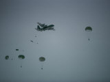Soldiers Parachute from a Plane During a Training Exercise