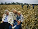 Smiling Grandparents Hold Their Grandson