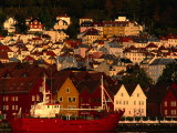 Fishing Vessel Moored in Front of Wooden Buildings on the Bryggen Waterfront, Bergen, Norway