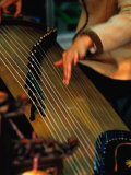 Student Playing Gu Zheng (Chinese Zither) in Shop in Xuanwu (Qianmen) Bejing, China