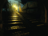 Buy Silhouetted Person Walking Up Lamp-Lit Cobblestone Street, Sighisoara, Romania at AllPosters.com