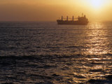Buy Cargo Ship at Sea Silhouetted at Sunset, Chile at AllPosters.com