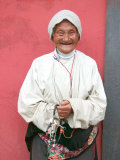 Elderly Tibetan Woman with Red Wall, Tagong, Sichuan, China