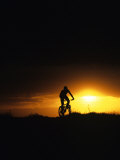 Mountain Biker Against Stormy Sunset, Fruita, Colorado, USA