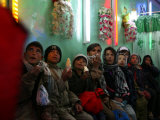 Afghan Boys Watch a Movie on a Television, Unseen, as They Eat Ice Cream at an Ice Cream Shop