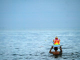 A Devotee Immerses the Idol of Elephant-Headed Hindu God Ganesh