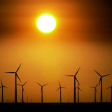 Buy A Group of Wind Turbines are Silhouetted by the Setting Sun at AllPosters.com