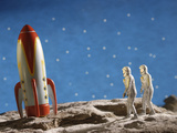 Buy Astronaut Figurines Standing Beside Toy Rocket at AllPosters.com