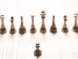 Silver Pawn on Newspaper Stock Market Report with Line of Chess Pieces