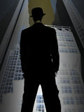 Man in Bowler Hat and Suit Standing in Front of City