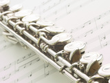 Silver Flute on Sheet of Music