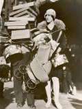 Woman Has Been Very Busy Shopping So Much So That Her Helper is Hidden Under a Pile of Parcels