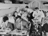 Buy An Airline Steward and Air Hostess Serve a Roast Meal to Flight Passengers at AllPosters.com