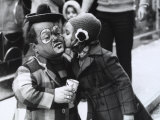 A Girl Delicately Kissing a Dwarf Dressed as a Clown on the Cheek