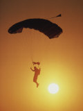 Parchutist Silhouetted Against a Sunset Sky