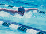 Young Man Swimmer Doing The Butterfly Stroke