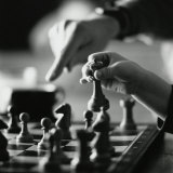 Monochromatic Image of an Adult and Child Playing Chess