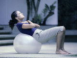 Side Profile of a Young Woman Exercising on a Fitness Ball