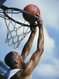 Man Slam-Dunking a Basketball