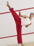 Young Man Kicking While Practicing Karate