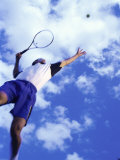 Low Angle View of a Man Serving with a Tennis Racket