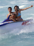 Buy Portrait of a Mid Adult Couple Riding a Jet Ski at AllPosters.com