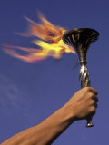 Person's Hand Holding a Flaming Torch