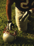 American Football Player Kneeling on the Field