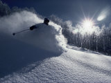 Skier in a Cloud of Snow with Sunburst