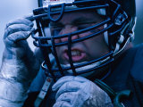 Close-up of an American Football Player Wearing a Helmet