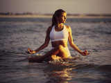 Young Woman Meditating at the Beach