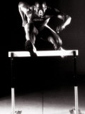 Buy Portrait of a Young Man Jumping over a Hurdle at AllPosters.com