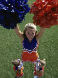 High Angle View of Cheerleaders Performing with Pom-Poms
