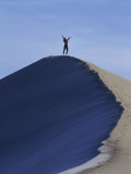 Woman Exercising on the Top of a Sand Dune