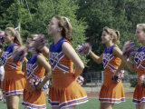 Group of Cheerleaders Cheering in a Field