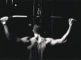 Buy Rear View of a Young Man Exercise on a Lateral Pull-Down Weight Machine at AllPosters.com