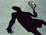 Shadow of a Male Tennis Player Playing Tennis