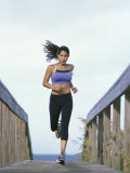 Young Woman Running with Headphones
