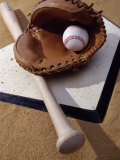 Baseball Bat with a Glove, and a Baseball on the Home Base