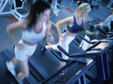 Buy High Angle View of Two Young Women Running on Treadmills in a Gym at AllPosters.com
