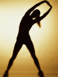 Silhouette of a Woman Exercising