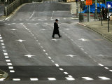 Buy An Orthodox Israeli Jew Walks Across an Empty Road During the Sabbath at AllPosters.com