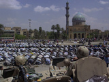 A Crowd of Iraqi Protesters Pray in Front of a U.S. Military Checkpoint