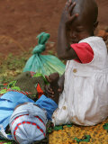 Buy A Young Boy Holds His Sisters Hand as She Waits for Treatment against Malaria at AllPosters.com