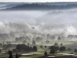 A Small Plane Descends Over Fog Covered Reeves Municipal Golf Course as It Lands at Lunken Airport