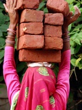 An Indian Woman Construction Worker Stacks Bricks on Her Head